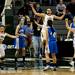 The Manchester High School girls basketball team celebrates defeating Saginaw Nouvel 57-52 on Saturday, March 16. Daniel Brenner I AnnArbor.com